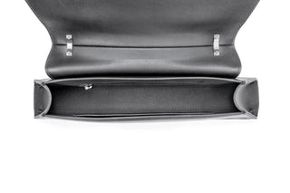 Top-down view of a dark gray leather clutch bag with its flap open