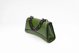 An olive green leather shoulder bag with a black chain strap and black trim