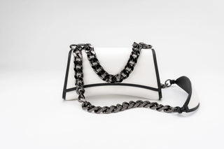 A white leather shoulder bag with black trim and a chunky black chain strap