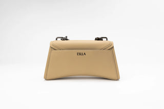 A beige leather handbag with a structured, curved silhouette, featuring a flap top with black hardware