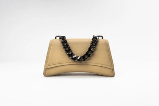 A beige leather handbag with a curved silhouette and a chunky black chain.