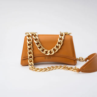 A small tan leather shoulder bag with a wide, chunky gold chain draped across the front.