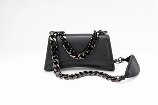 A black leather shoulder bag with a distinctive curved silhouette and a chunky, dark metallic