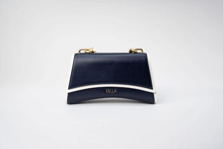 A navy blue leather handbag with a curved white stripe and gold-tone hardware