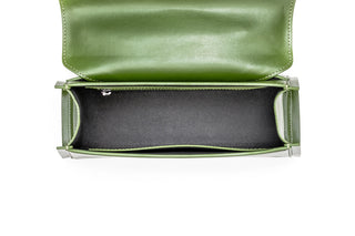 A top-down view of a green leather clutch bag with the flap open, showing a black fabric-lined.