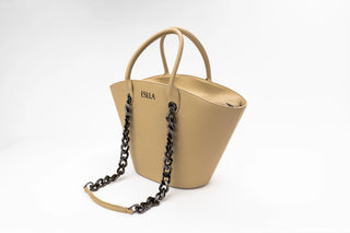 A structured tan leather handbag with double top handles and a black chain-link shoulder strap
