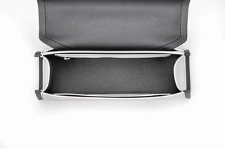 A top-down view of a black leather clutch bag with a silver-tone metal frame