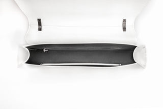 A white leather clutch bag shown open from a top-down view, revealing a black interior lining and silver-tone hardware.